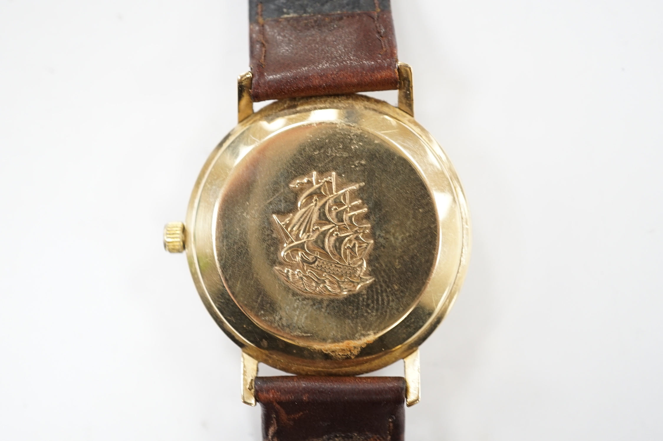 A gentleman's 9ct gold Longines Flagship automatic wrist watch, with baton numerals and date aperture, on associated leather strap.